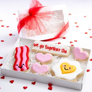 Made with our incredible thick soft and yummy sugar cookie recipe, each cookie is heat sealed, placed in a white window box and tied with ribbon.